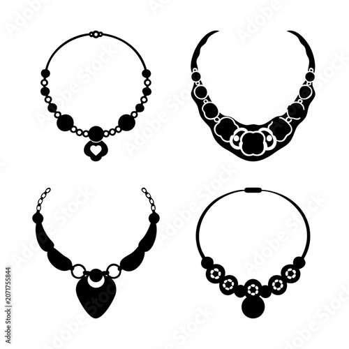Four elegant black and white jewelry necklaces - A minimalist set of four stylish black and white necklace designs with pendants, perfect for fashion or editorial use.