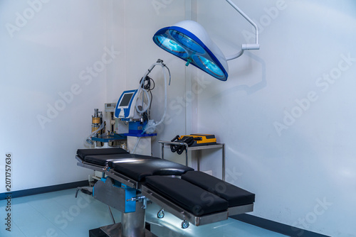Surgical equipment, including an operating table, in a hospital operating room.