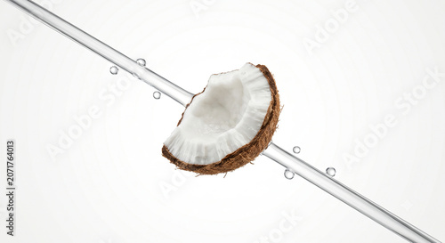 Distant shot of a coconut chunk with a sharp diagonal transparent water jet stream
