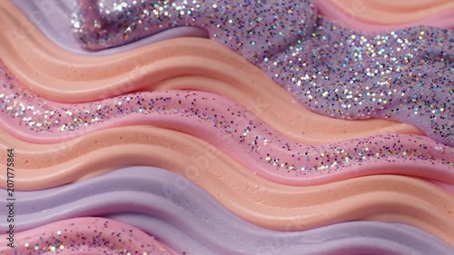 Pastel wavy frosting with glitter creates a sweet dessert texture