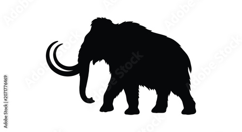 Foto A woolly mammoth stands in profile depicted as a stark black silhouette elephant
