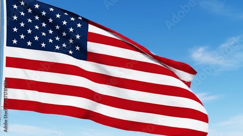 The American flag waves proudly against a clear blue sky with clouds