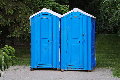 Canvas Print Pair of blue portable chemical toilets providing public restroom facilities at a