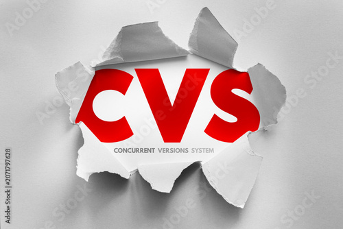 Obraz na plátně CVS Concurrent Versions System text revealed through torn paper representing ver