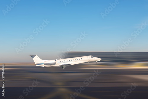 Foto Mid size modern vip private jet departure and take-off on airport runway
