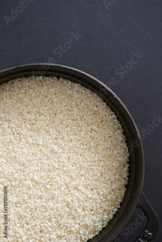 Raw rice in a cast iron pot