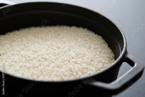 Photos Raw rice in a cast iron pot