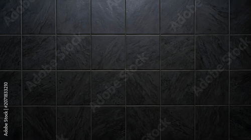 Dark gray stone tile wall background with subtle textured surface and clean geometric grid pattern