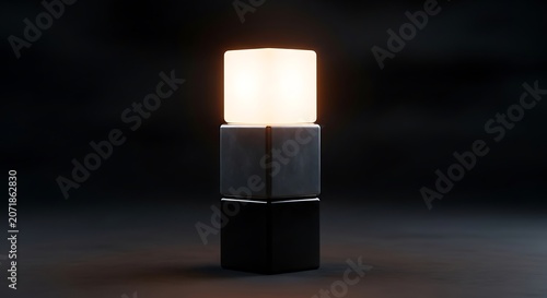 A modern table lamp with a glowing white shade on a dark background