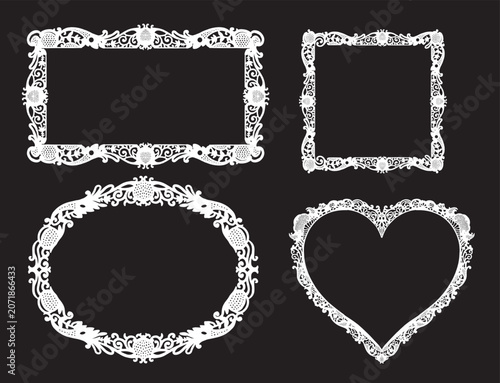 Four ornate white picture frames on black background