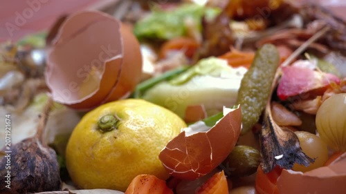 Food waste with discarded vegetable scraps, eggshells and lemon peel for composting and recycling concept. High quality 4k footage