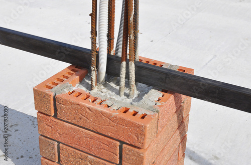 Brick fence pillar construction with masonry and reinforcement steel