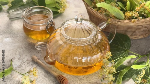 Healthy linden tea with honey brewing in a glass teapot