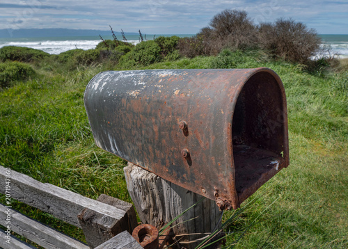 Rusty mailbox near the coast of Orepuki coast New Zealand. Westcoast Tasman Sea