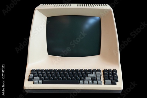 Old personal computer isolated on black background. Vintage PC.