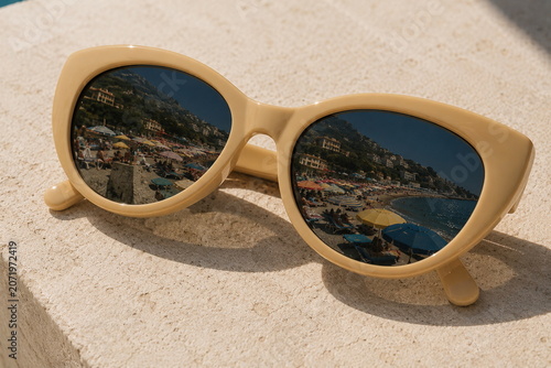 Close Up Retro Sunglasses Reflecting a Crowded Beach Scene