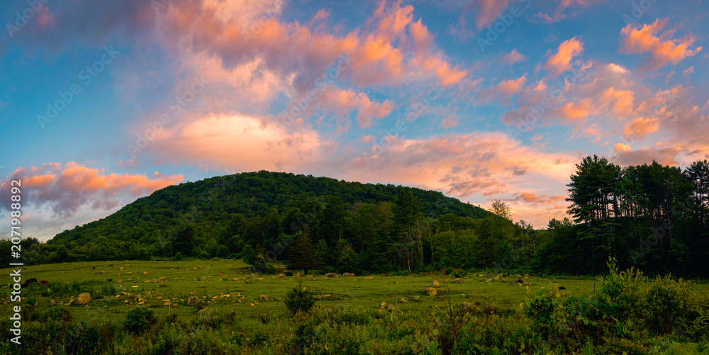 Fototapeta premium Sunrise Panoramic cloudscape over Mt Ascutney State Park meadow and Little Ascutney State Wildlife Management Area in Wethersfield, Vermont, United States