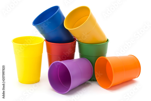 Stack of colorful plastic cups on white background with multi colored, colorful
