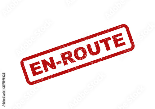 Fotografie Red rubber stamp with the text en route in a rectangular frame