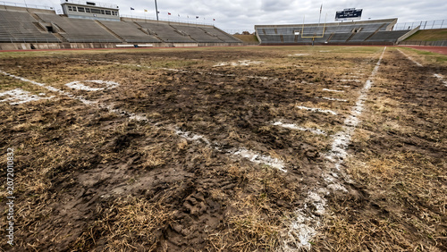 Texture of dry worn out grass and dirt patches on an old soccer field