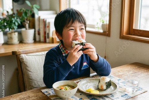 Japanese Boy Eating Onigiri Rice Ball for Healthy Breakfast at Home
