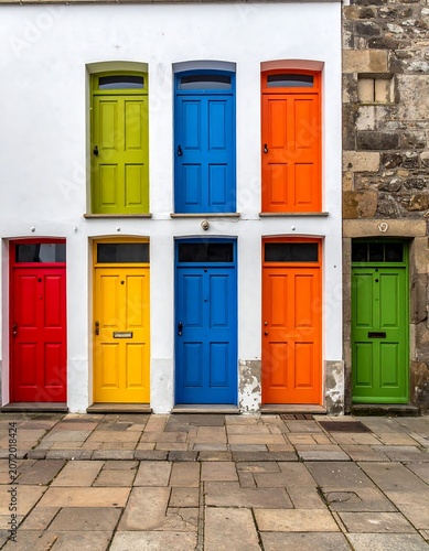 Colorful modern apartment building exterior with bright doors.