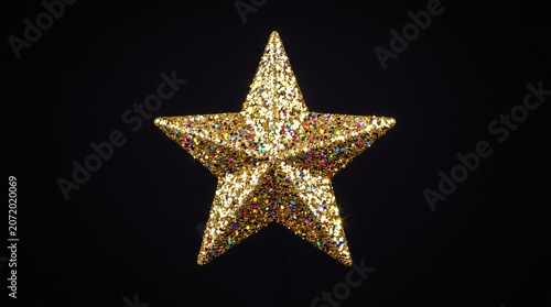 Golden star on black background festive Christmas ornament