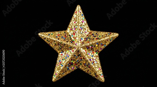 Golden star on black background festive Christmas decoration with glitter and sparkle for holiday season