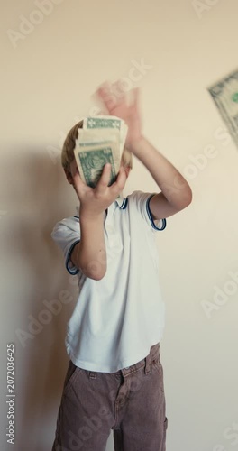 Little blond boy making it rain with cash