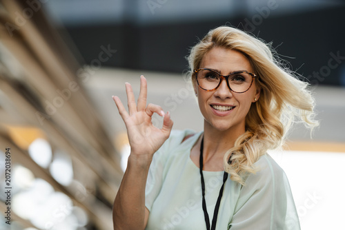 Business Professional Showing Approval Gesture in Modern Urban Office Setting