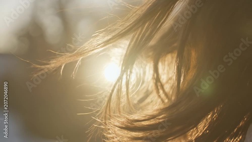 Close-up of radiant hair backlit by golden sun illustrating natural beauty and freedom outdoors