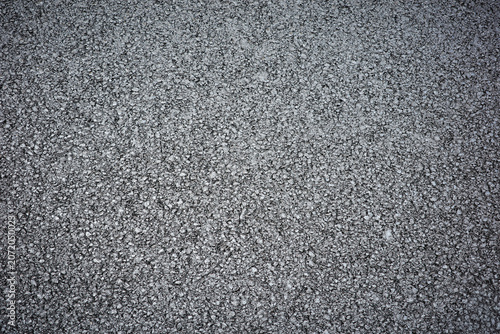 Rough grey aggregate road surface texture