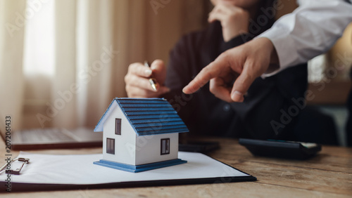 Businessman, house and condo sales representative Hand over the keys to the customer and sign the sales or rental contract according to mutual agreement in the office. Real estate business concept