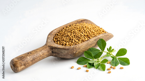 Dried fenugreek seeds displayed in a rustic wooden scoop with fresh green fenugreek leaves, symbolizing a natural, versatile herb and spice essential for culinary and wellness applications