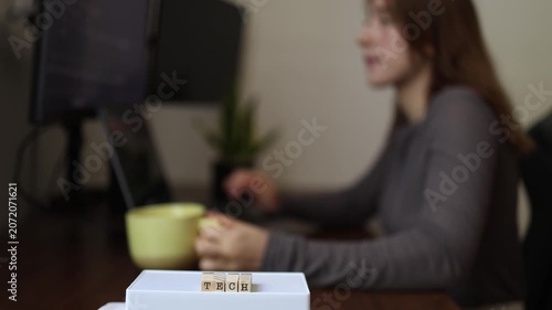 Technology work routine as woman drinks coffee while coding at computer highlighting developer lifestyle programming focus productivity and modern digital workspace