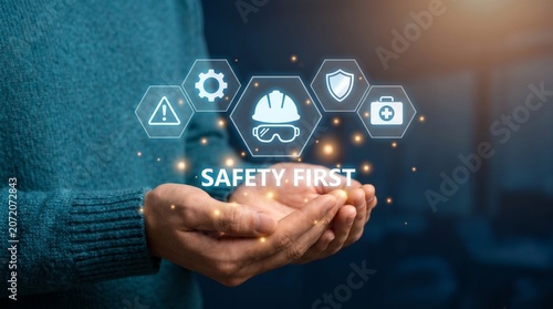 Person holding digital icons representing safety first and workplace protection