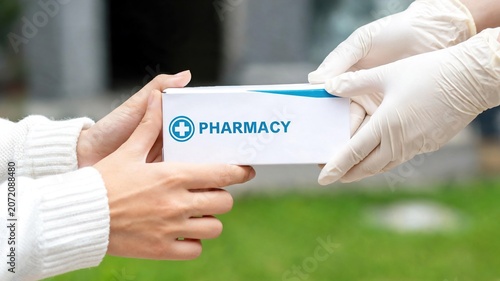 Pharmacist Giving Medication Box to Patient Outdoors - Healthcare
