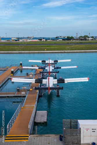 Фотография Twin engine floatplanes moor at the Male seaplane terminal in Maldives
