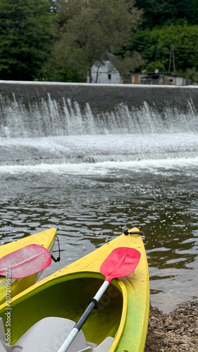 Colorful kayaks lined up on the riverbank ready for a paddling adventure