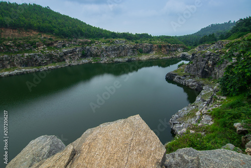 Top view of Tarpania Lake, Marble Lake, Blue Dam, Patal Dam or Durga Bera,a scenic lake in the Ajodhya Hills of Purulia, West Bengal, India. Water surrounded by sharp, white, marble-like rocky cliffs.