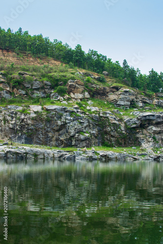 Sharp, white, marble-like rocky cliffs of Tarpania Lake, Marble Lake, Blue Dam, Patal Dam or Durga Bera,a scenic lake in the Ajodhya Hills of Purulia, West Bengal, India. Lake has Deep blue water.