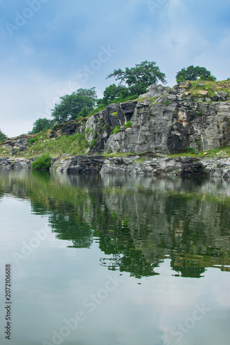 Tarpania Lake, Marble Lake, Blue Dam, Patal Dam or Durga Bera,a scenic lake in the Ajodhya Hills of Purulia, West Bengal, India. Deep blue water surrounded by sharp, white, marble-like rocky cliffs.