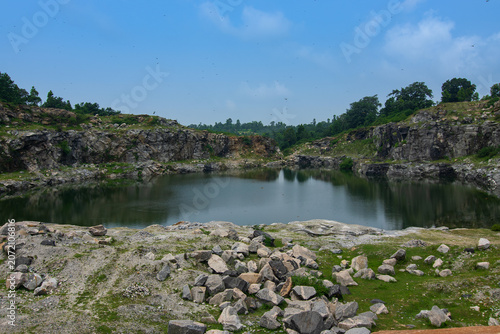 Tarpania Lake, Marble Lake, Blue Dam, Patal Dam or Durga Bera,a scenic lake in the Ajodhya Hills of Purulia, West Bengal, India. Deep blue water surrounded by sharp, white, marble-like rocky cliffs.