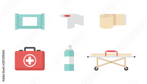 First aid medical items with wet wipes, plaster, bandage, first aid kit, spray, and stretcher on white background.