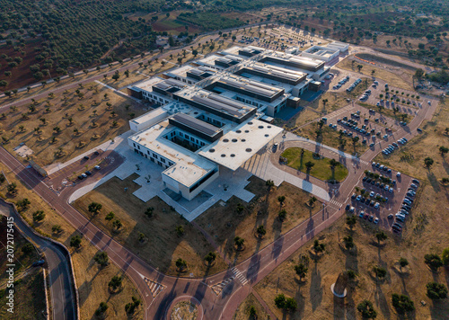 Monopoli, Italy - 23 June 2026: Aerial view of the newly opened Monopoli-Fasano Hospital, featuring modern architecture, flat roofs, and surrounding parking areas in the Apulia region.