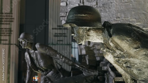 Bronze Soldiers of Warsaw Uprising Monument Illuminated at Night