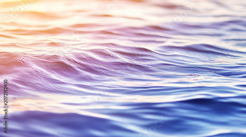 Gentle waves create smooth gradient of colors in water, evoking serene and calming atmosphere
