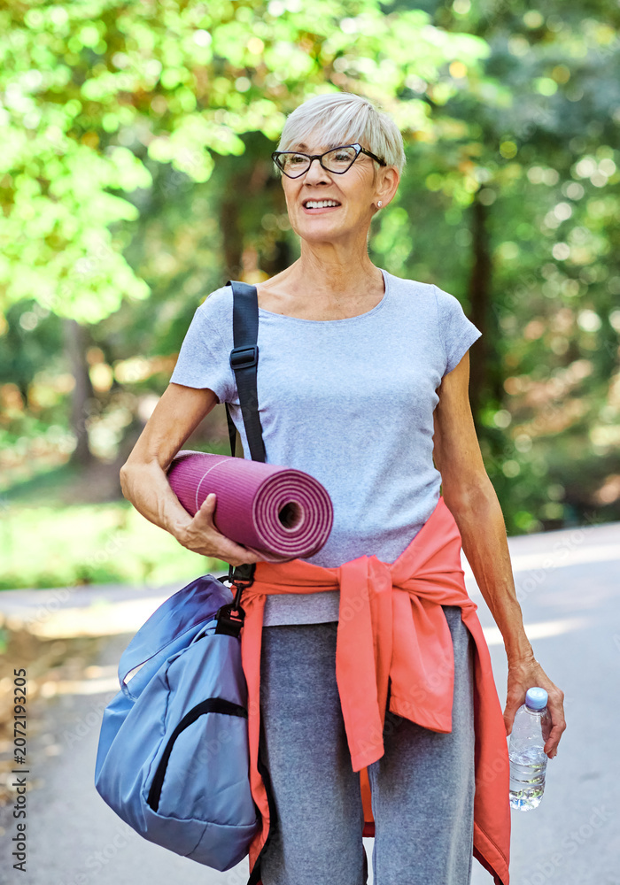 Obraz premium Portrait of a happy active senior woman posing after exercising outdoors, healthy lifestyle and vitality concepts
