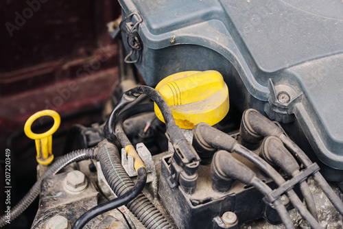 Photos Car engine compartment with oil filler cap and ignition system components