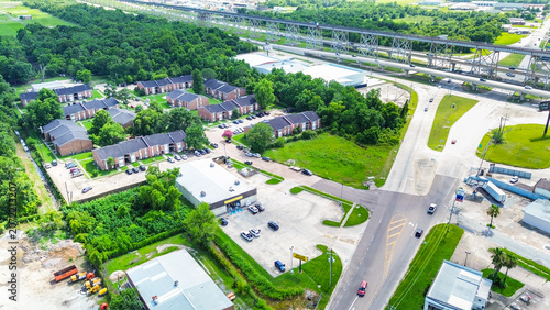 Aerial view of a suburban neighborhood with apartment complexes and a commercial area